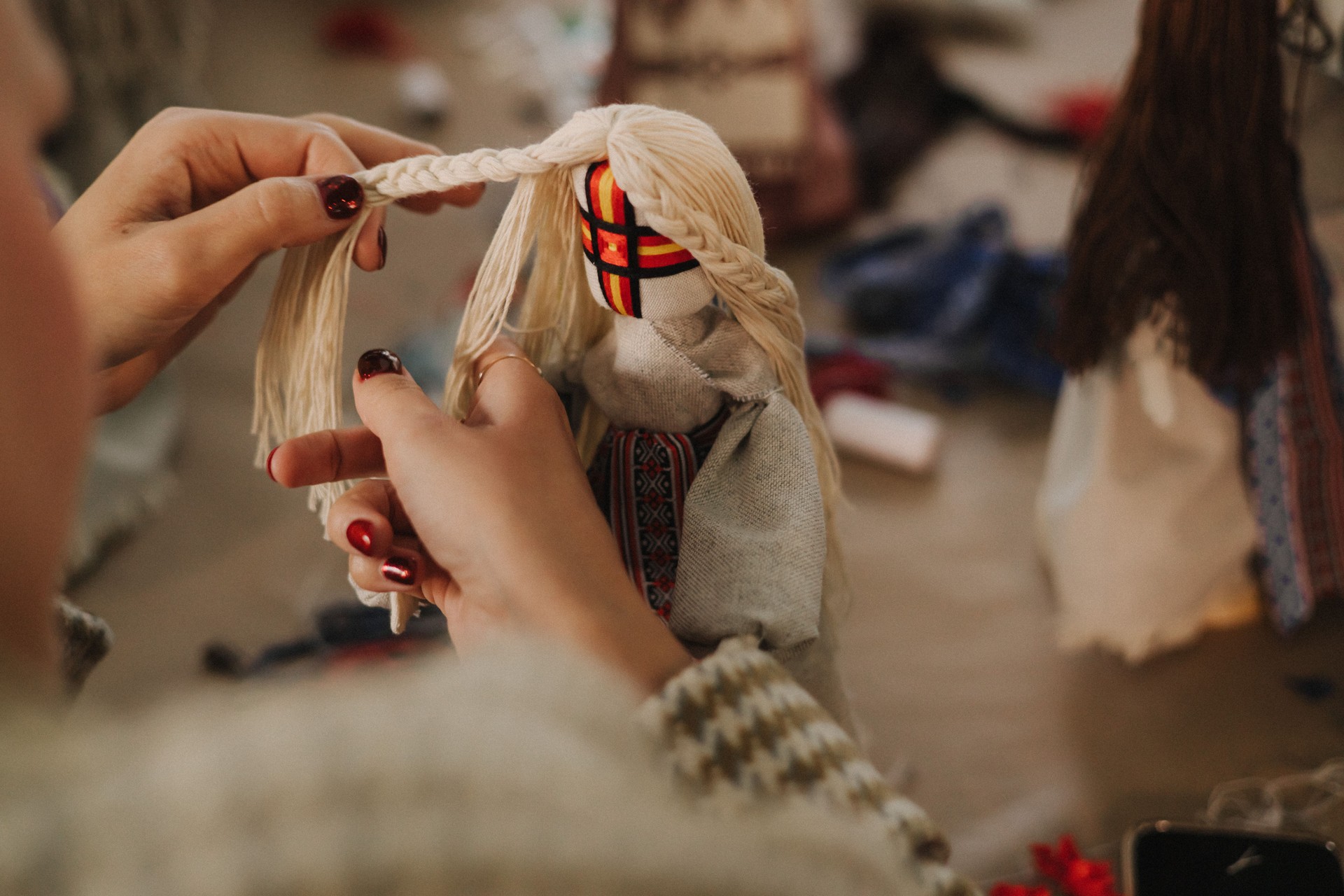 Ukrainian traditional Motanka doll in national costume. Master class on making traditional symbol. Nation code. Cultural heritage. Craft amulet. Patriotic handicrafts. Part of the series. Soft focus